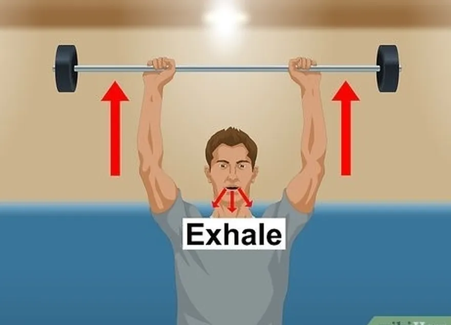 Passo 6 Expire enquanto empurra a barra diretamente acima da sua cabeça.