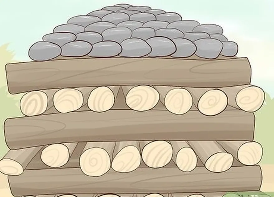 Passo 5 Empilhar a madeira e as pedras vulcânicas no chão para fazer uma pilha de fogo.